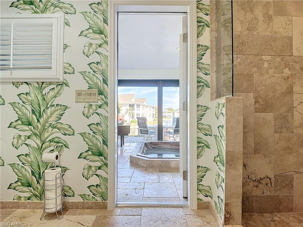 1659 Sandpiper Street, Unit E Naples, FL 34112 - Photo 29 of 50 wooden floor with a mirror