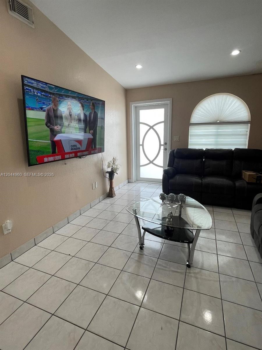 7681 Northwest 178th Terrace Hialeah, FL 33015 - Photo 3 of 11 a living room with furniture and a painting on the wall