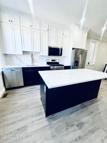 a large kitchen with stainless steel appliances granite countertop a large counter top and a stove