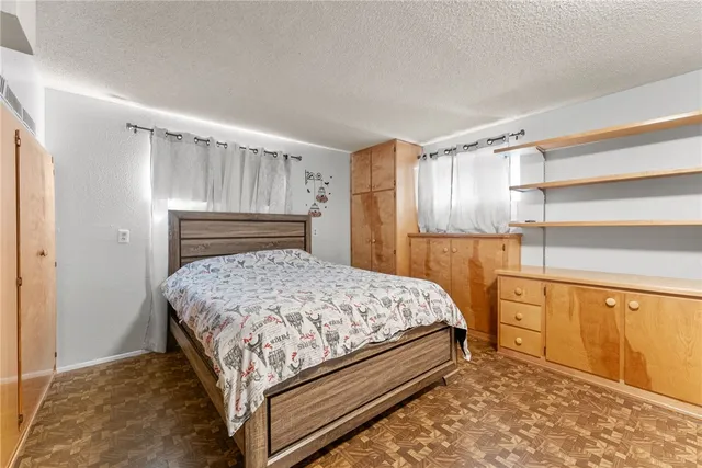 a bedroom with a bed and a cabinets