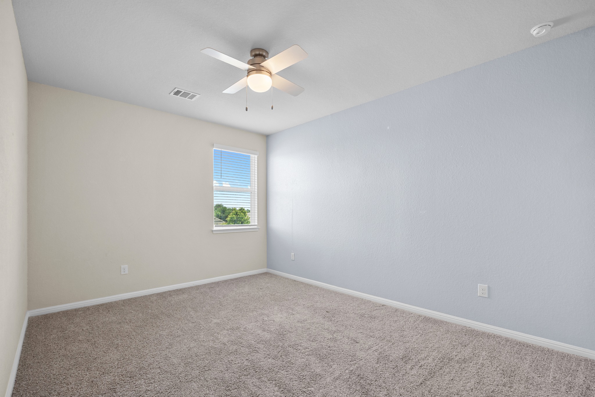 2413 Starhill Ranch Street Georgetown, TX 78628 - Photo 28 of 40 an empty room with a chandelier fan and windows