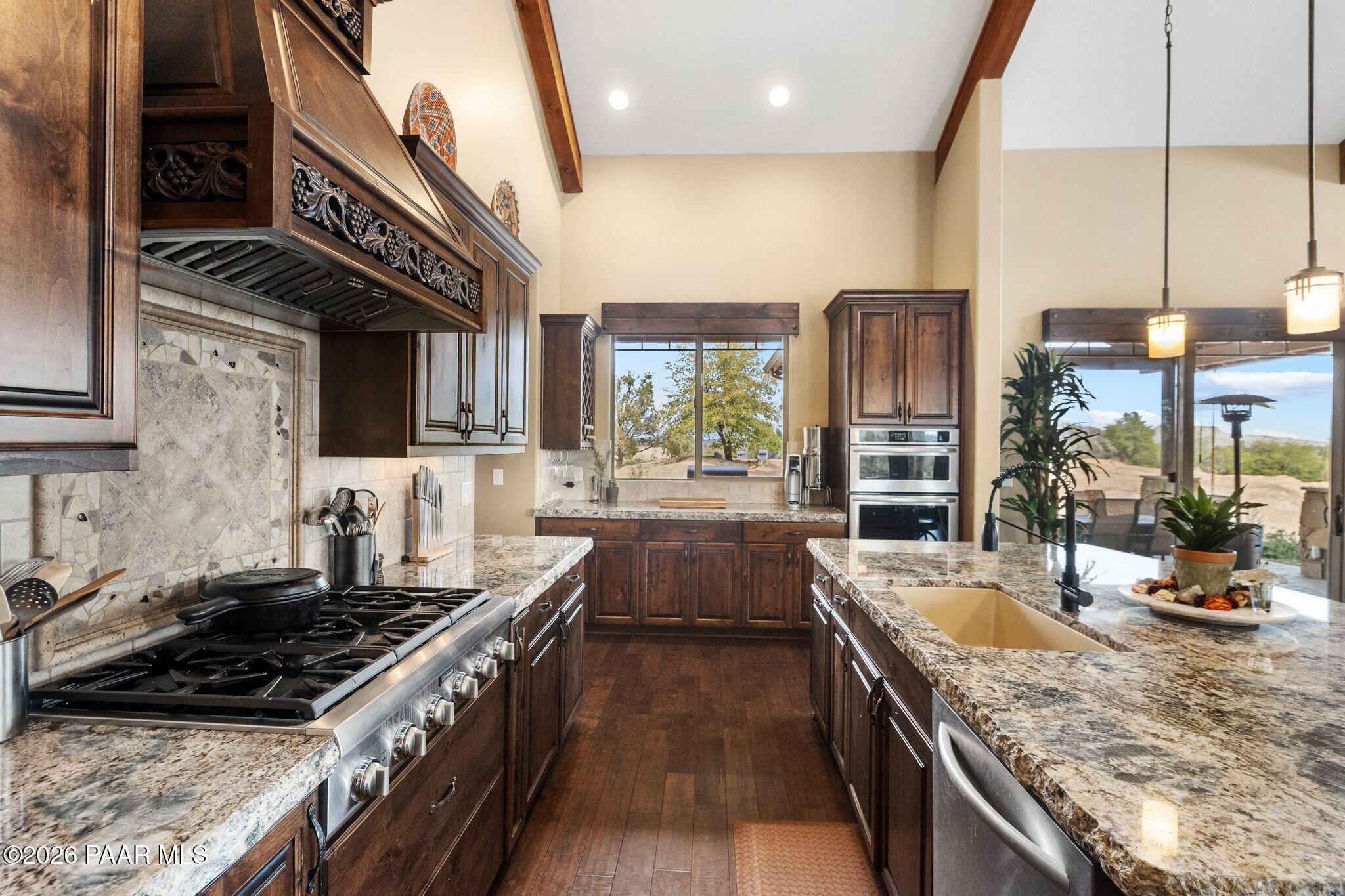 4290 Fort Bridger Road Prescott, AZ 86305 - Photo 15 of 50 a kitchen with stainless steel appliances granite countertop a stove and a sink