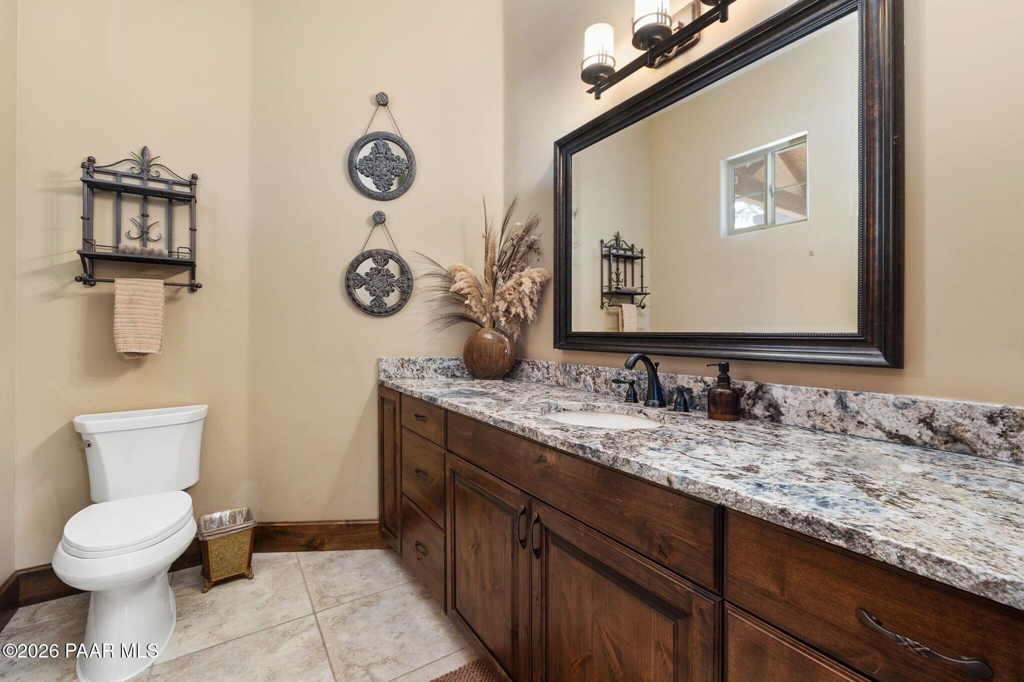 4290 Fort Bridger Road Prescott, AZ 86305 - Photo 29 of 50 a bathroom with a granite countertop toilet sink and mirror