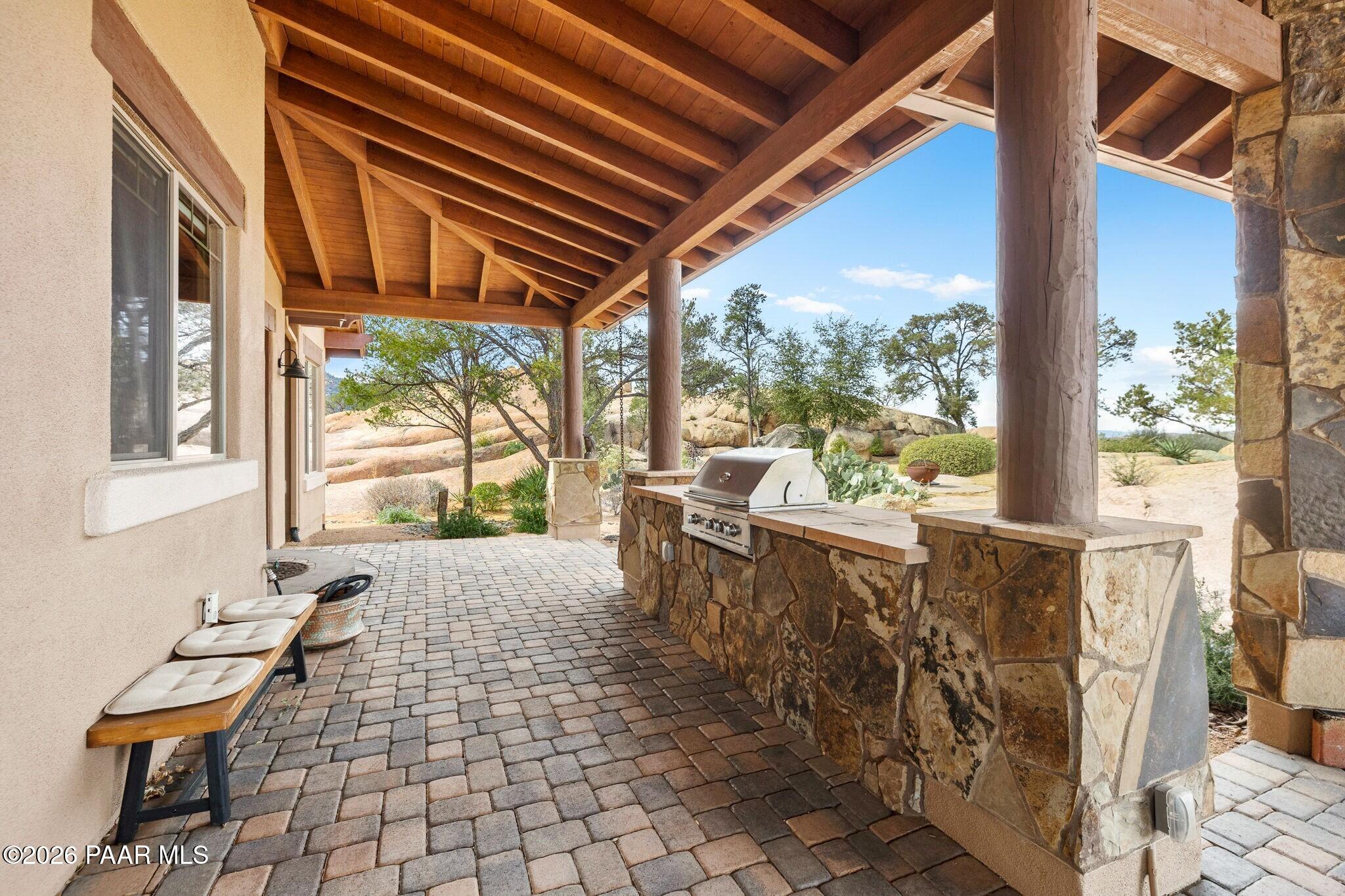 4290 Fort Bridger Road Prescott, AZ 86305 - Photo 35 of 50 a view of a patio with table and chairs and wooden floor