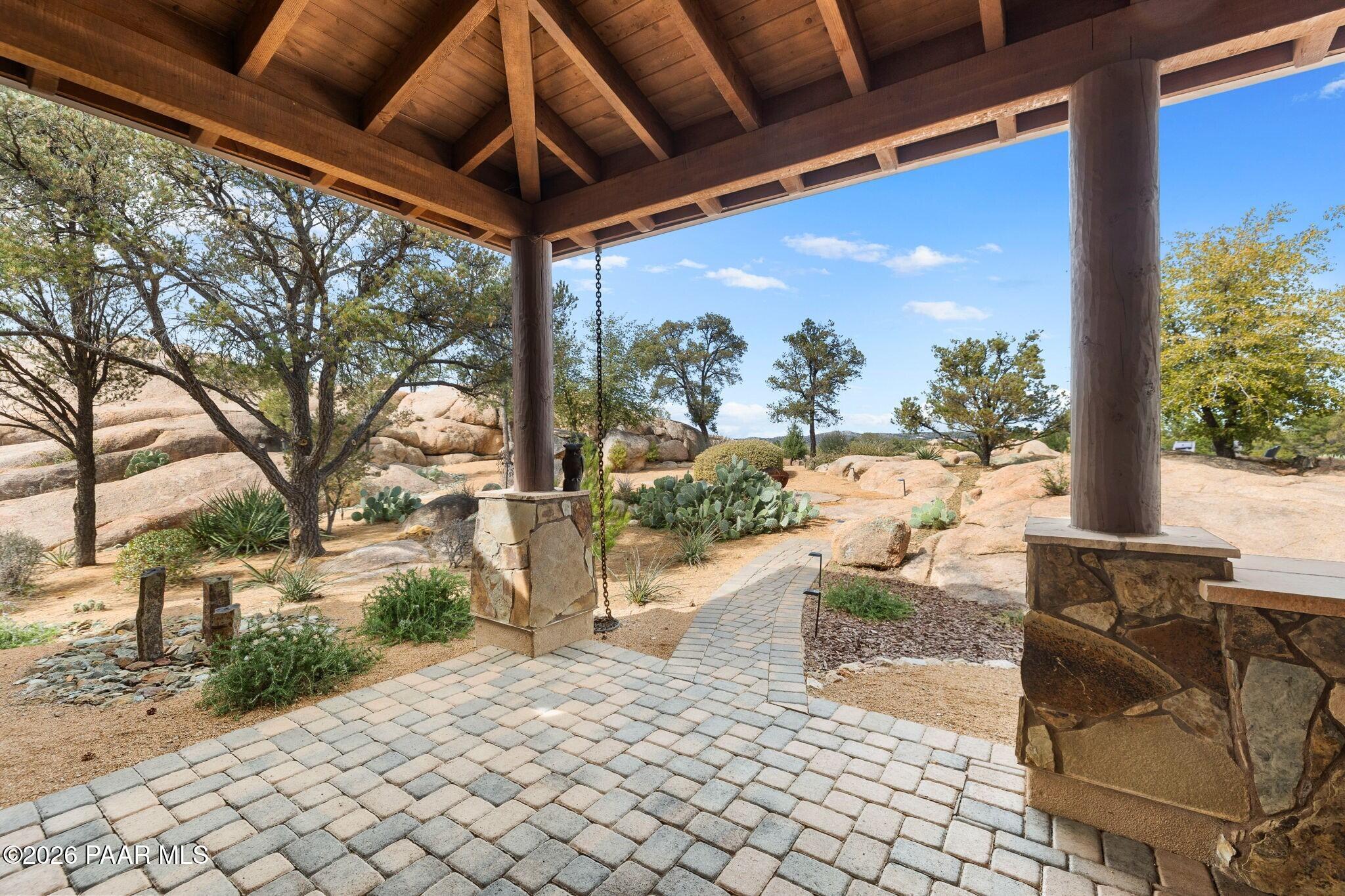 4290 Fort Bridger Road Prescott, AZ 86305 - Photo 36 of 50 a view of a patio with table and chairs potted plants and floor to ceiling window