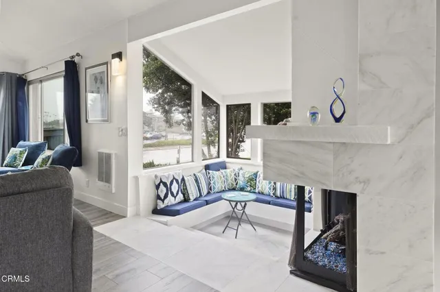 a view of a dining room with furniture large windows and wooden floor
