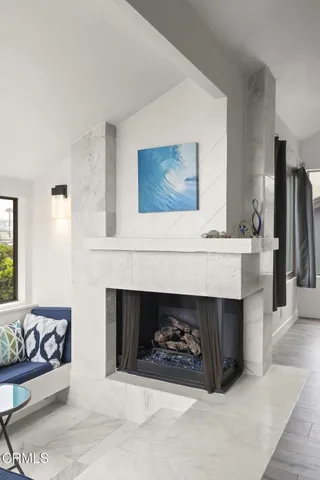 a dining room with furniture a large window and a rug