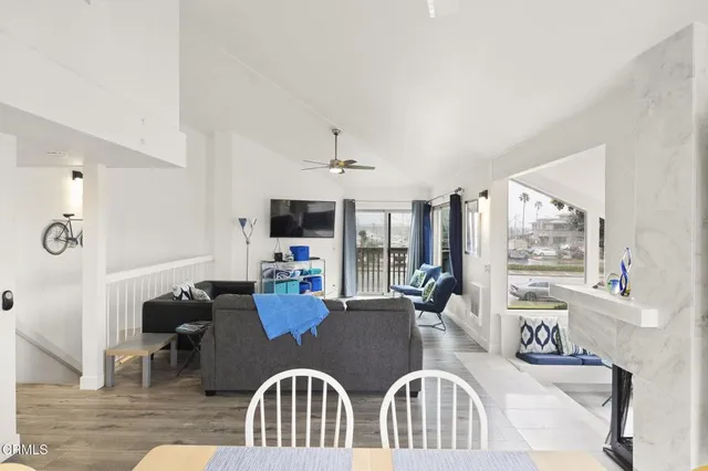 a large white kitchen with a large window and stainless steel appliances