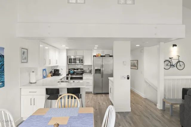a bedroom with a bed and a flat tv screen on the dresser