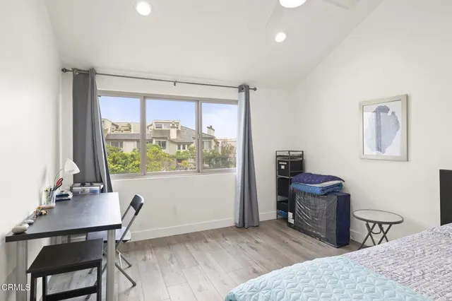 a bedroom with a bed and a desk