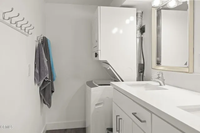 a bathroom with a sink a mirror and shower