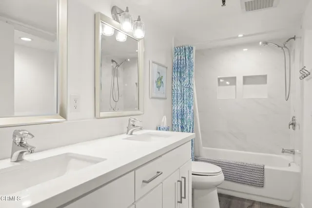 a bathroom with a sink vanity and mirror
