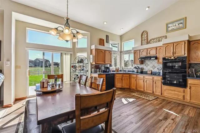 a kitchen with stainless steel appliances kitchen island granite countertop a refrigerator and a stove top oven