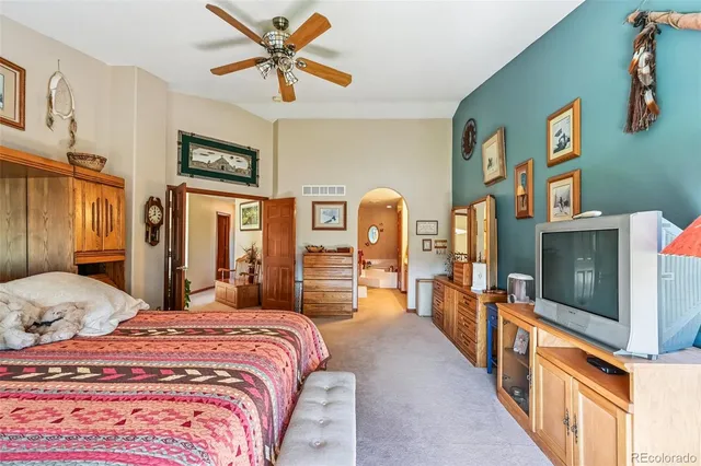 a large bathroom with a tub sink and mirror