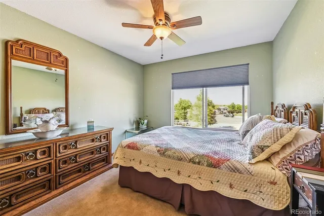 a bedroom with a bed and a bookshelf