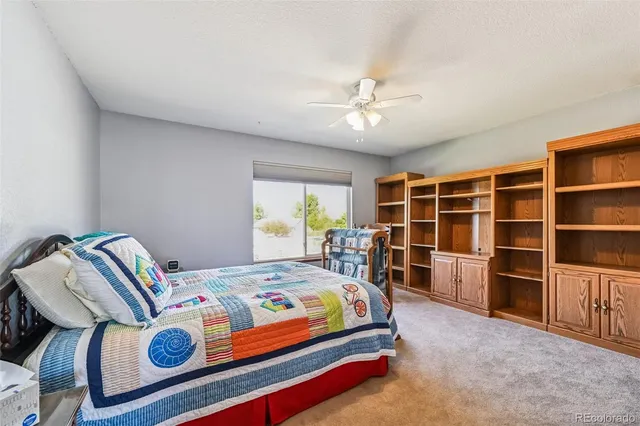 a view of a livingroom with workspace and a window