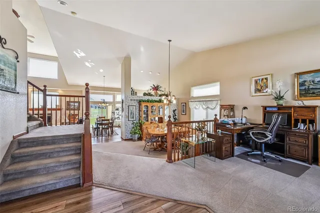 a view of a hallway with wooden floor and potted plants