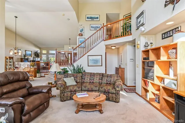 a living room with furniture kitchen view and a fireplace