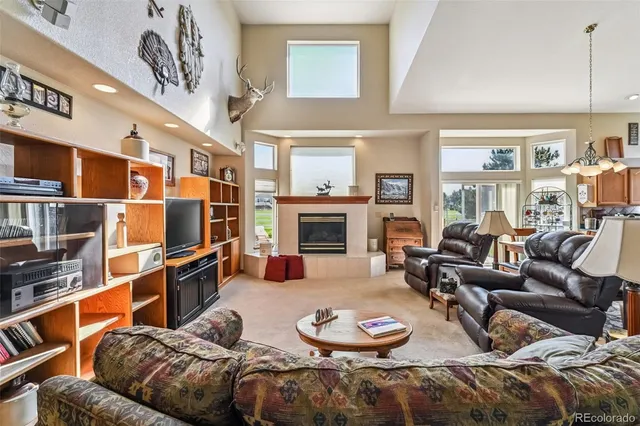 a view of a dining room with furniture a chandelier and wooden floor