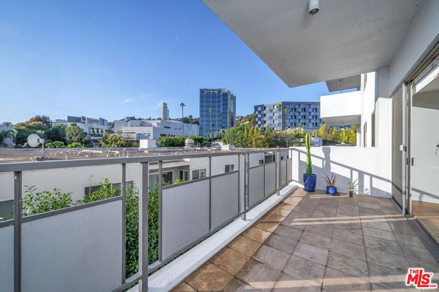 a view of a balcony with wooden floor