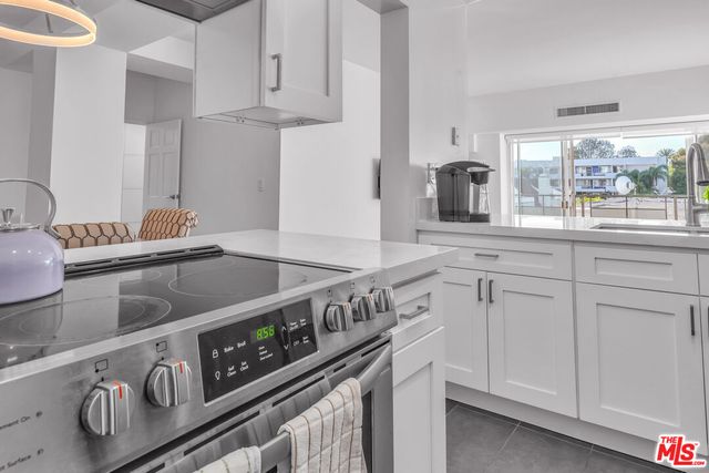 a kitchen with stainless steel appliances granite countertop a sink and a stove