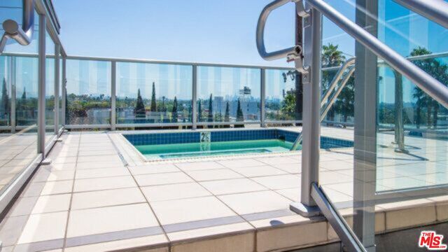 a swimming pool with view of building in the background