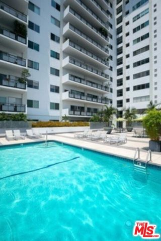 a swimming pool with outdoor seating and yard