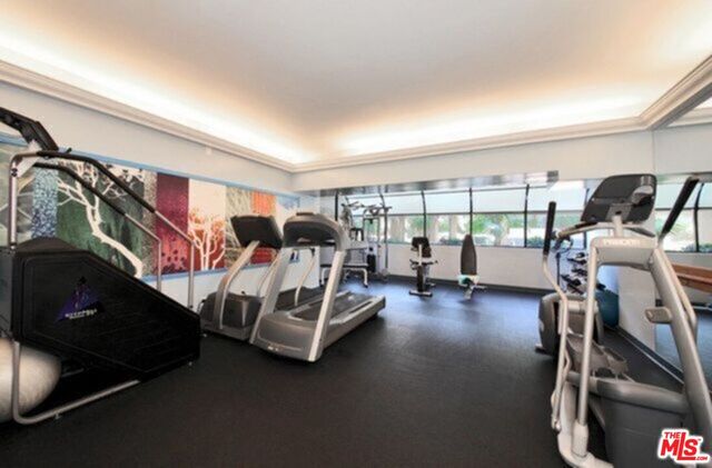 a bedroom with furniture and a large window