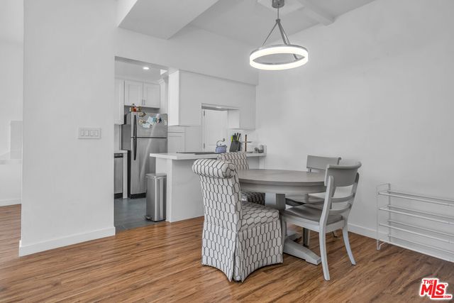 a dining room with furniture and wooden floor