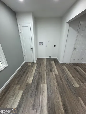 a view of a room with wooden floor