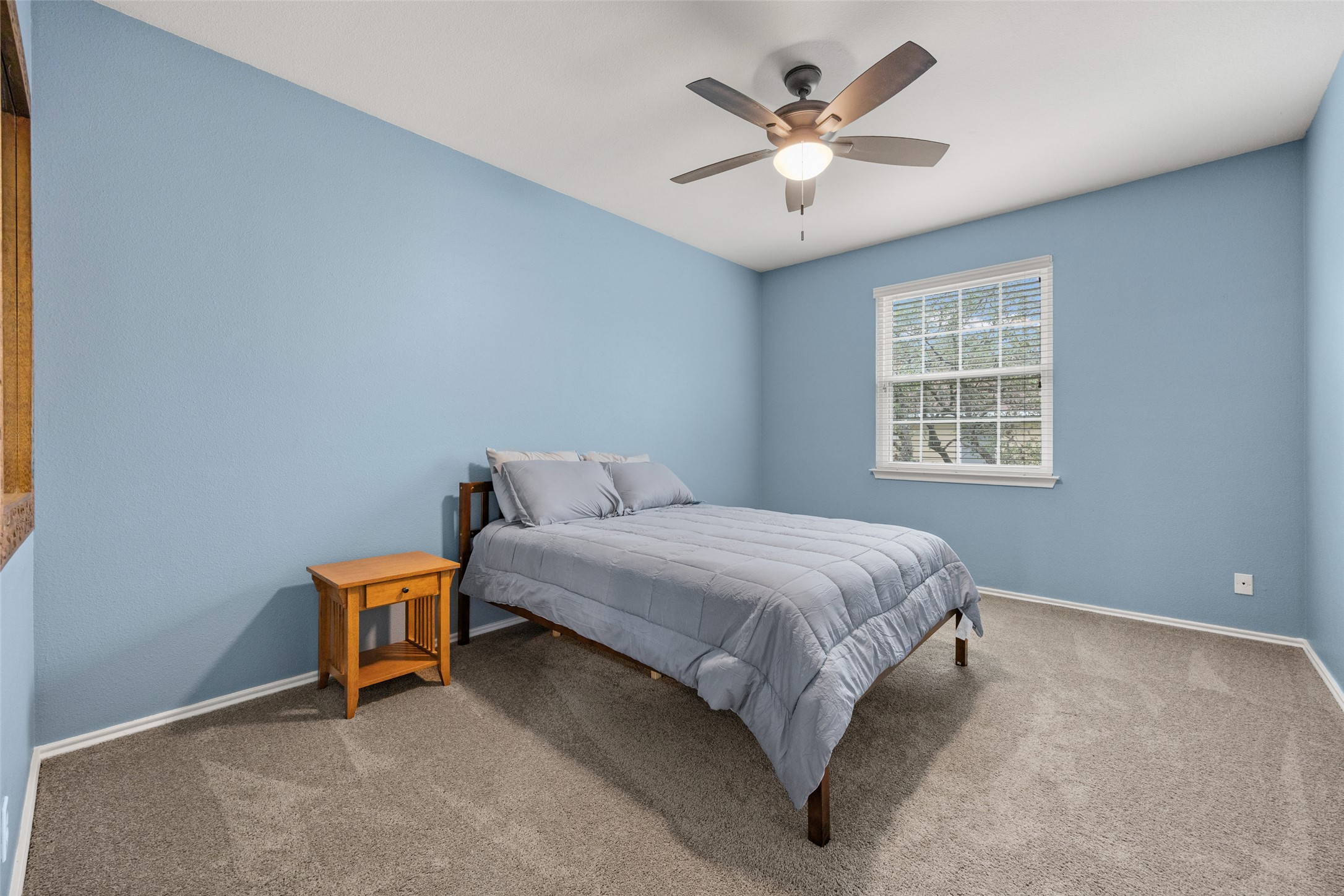 8610 Axis Drive Austin, TX 78749 - Photo 21 of 29 a spacious bedroom with a bed and a chandelier