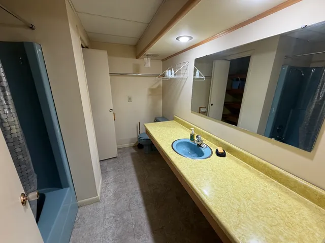 an empty room with windows and closet