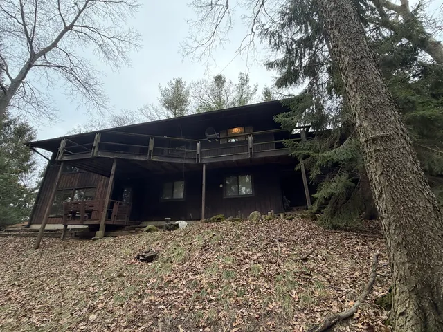a backyard of a house with barbeque oven and seating space