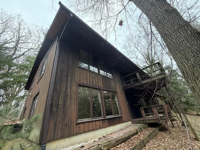 a large kitchen with a counter top space a sink stainless steel appliances and cabinets