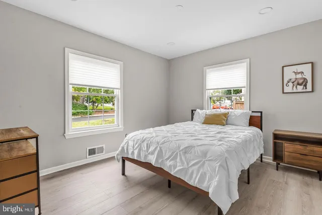 a bedroom with a bed lamp and a window
