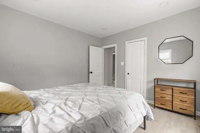 a bedroom with a bed and a mirror