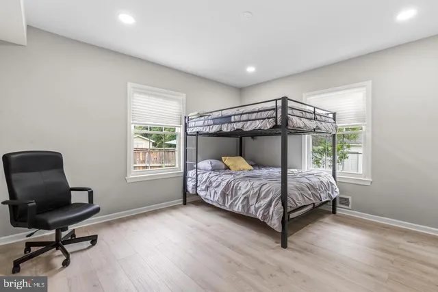 a bedroom with a bed chair and a window