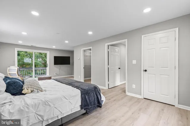 a bedroom with a large bed and a large window