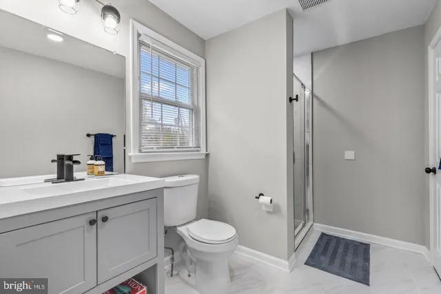 a white toilet sitting next to a bathroom sink