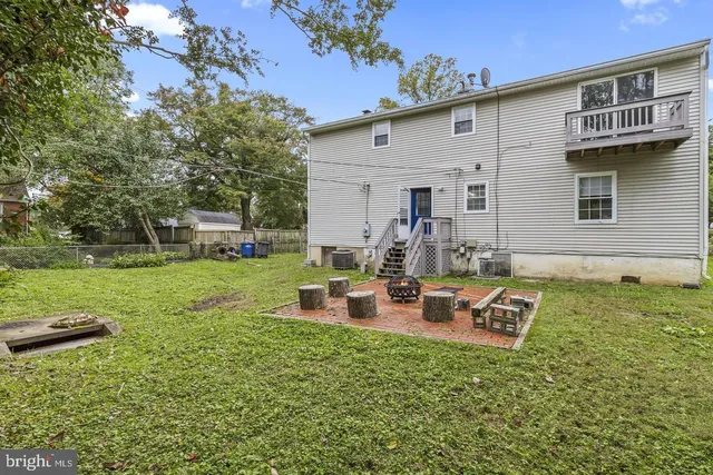a view of a house with backyard sitting area and garden