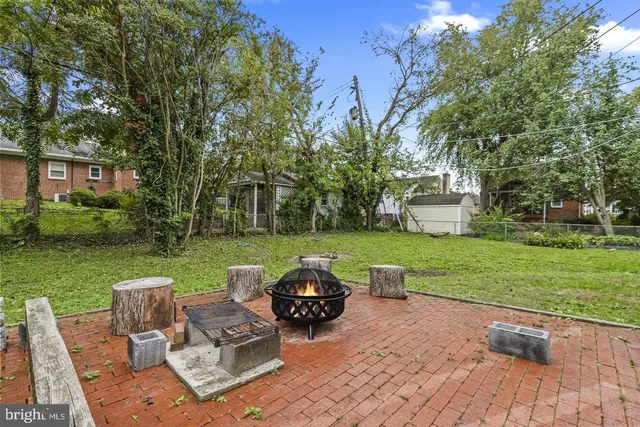 a view of a patio with couches chairs and a yard