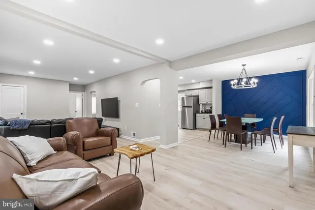 a living room with furniture and a dining table