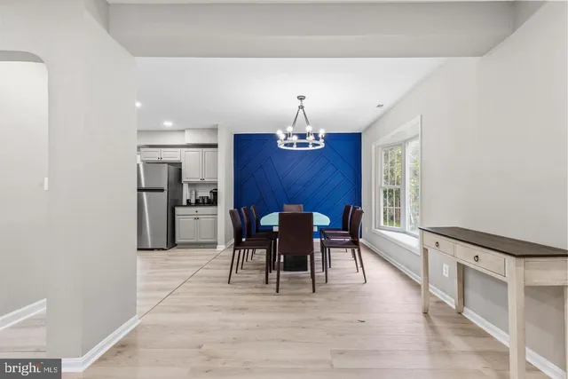 a view of a dining room with furniture and chandelier