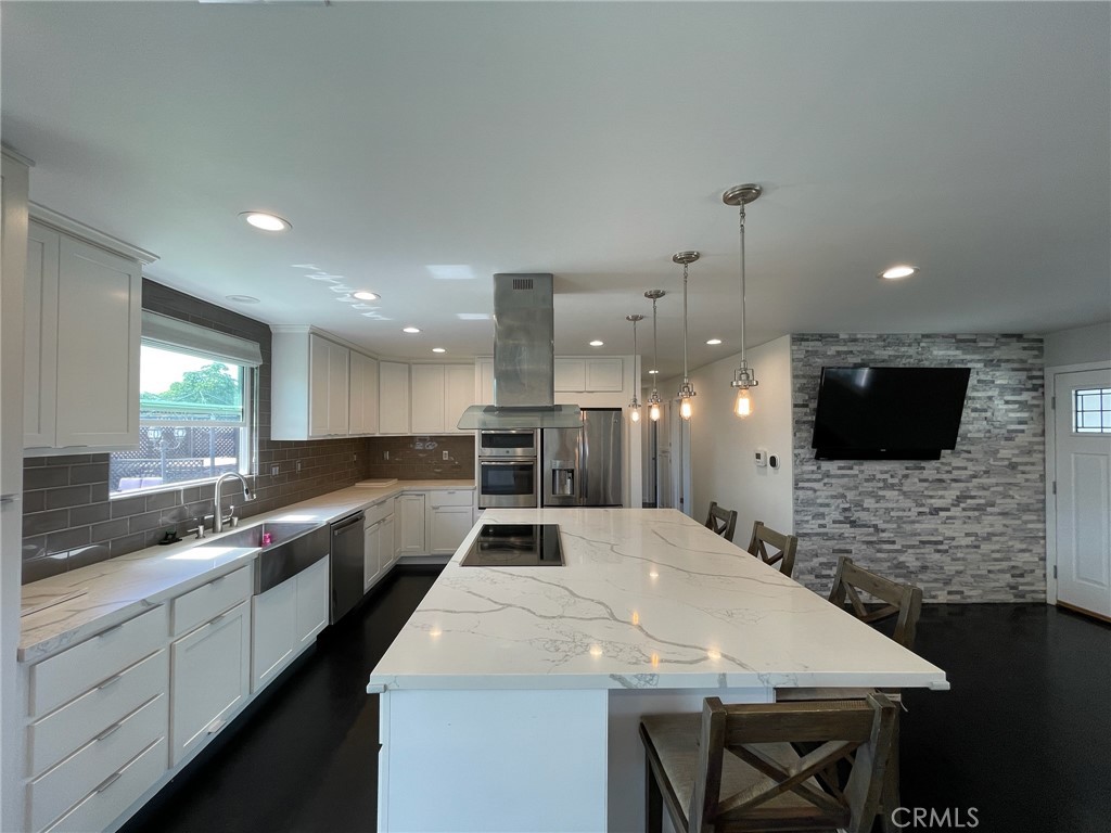 5352 Edinger Avenue Huntington Beach, CA 92649 - Photo 1 of 17 a large kitchen with a sink and a large window