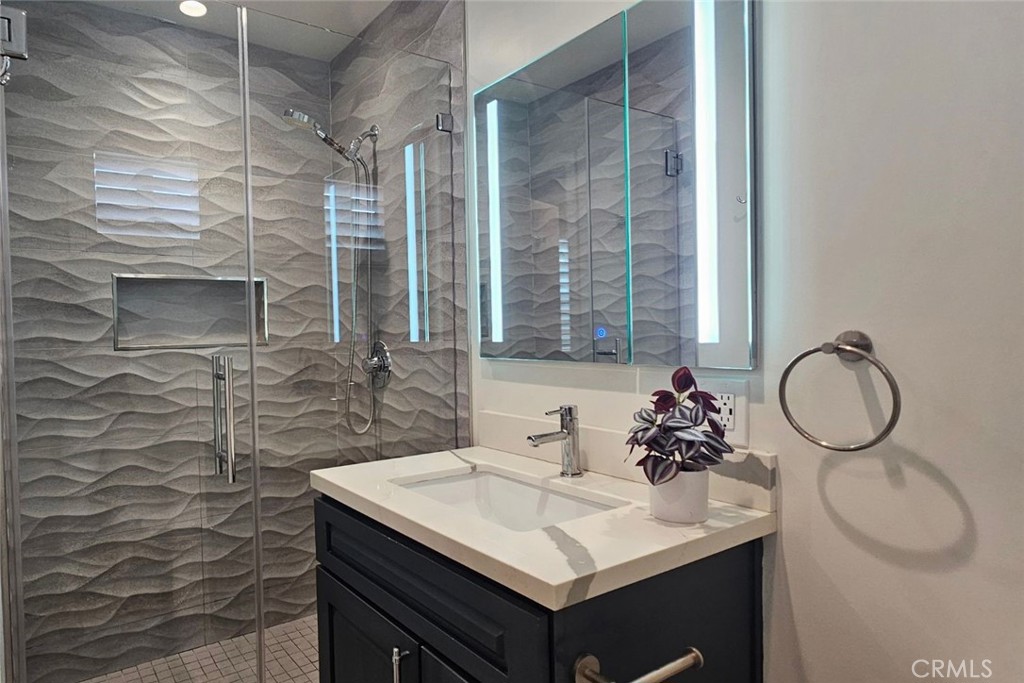 5352 Edinger Avenue Huntington Beach, CA 92649 - Photo 11 of 17 a bathroom with a sink a toilet and mirror