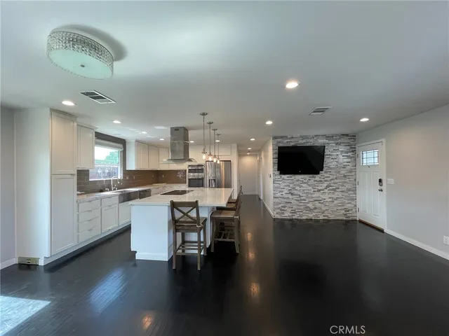 a kitchen with white cabinets and sink
