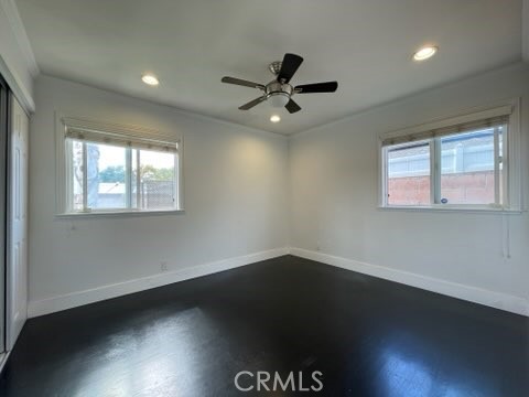 5352 Edinger Avenue Huntington Beach, CA 92649 - Photo 4 of 17 a view of an empty room with wooden floor and a window