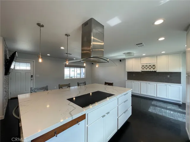 a bathroom with a granite countertop toilet sink and mirror