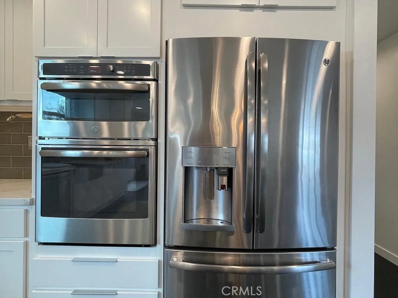 5352 Edinger Avenue Huntington Beach, CA 92649 - Photo 7 of 17 a metallic refrigerator freezer sitting in a kitchen