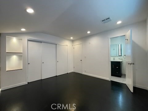 5352 Edinger Avenue Huntington Beach, CA 92649 - Photo 8 of 17 an empty room with wooden floor and windows